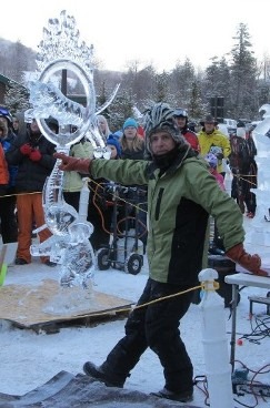 Winter festival construction team working together outdoors on large snow blocks