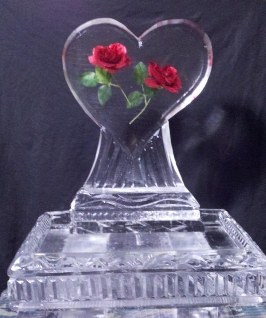 Heart-shaped ice sculpture with red roses