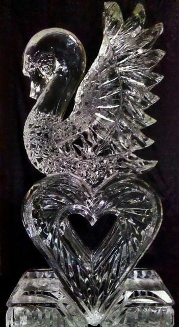 Intricate ice sculpture showing detailed textures of swan feathers