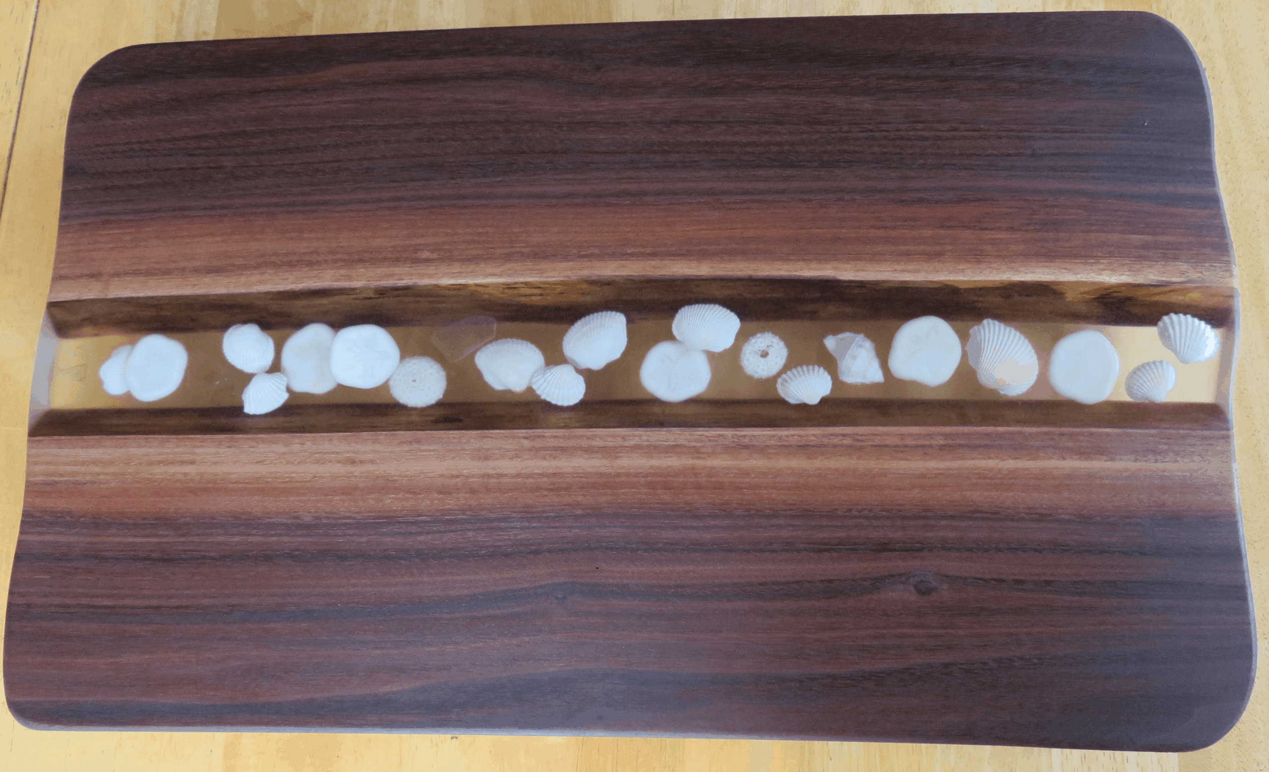 Custom wooden board featuring smooth white circular stone inlays