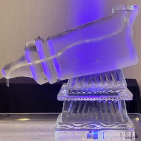 Purple illuminated ice bar with drink luge