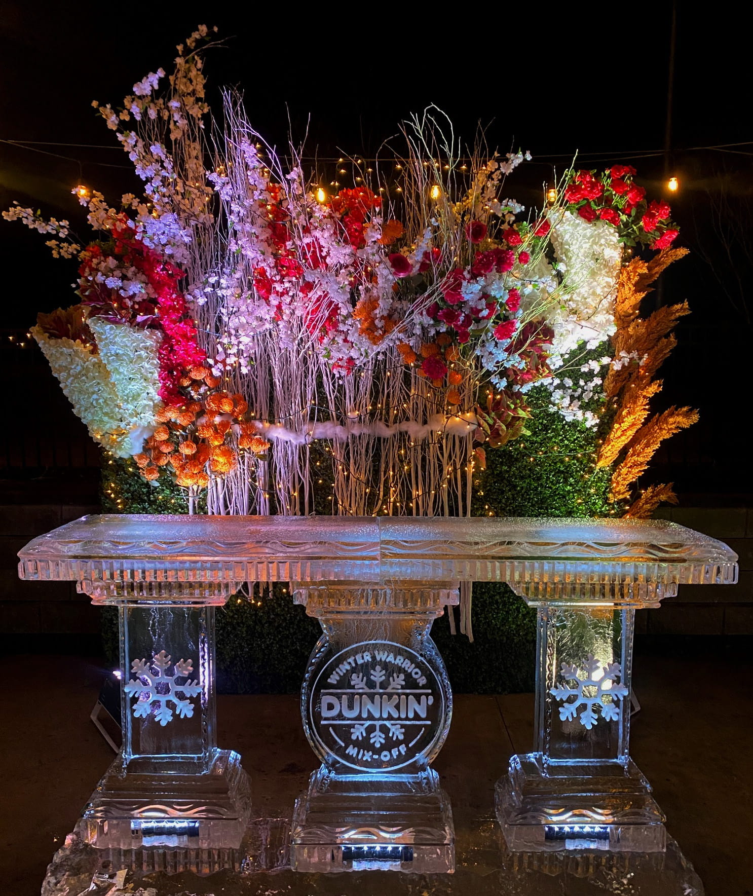 Colorful illuminated floral ice sculpture centerpiece
