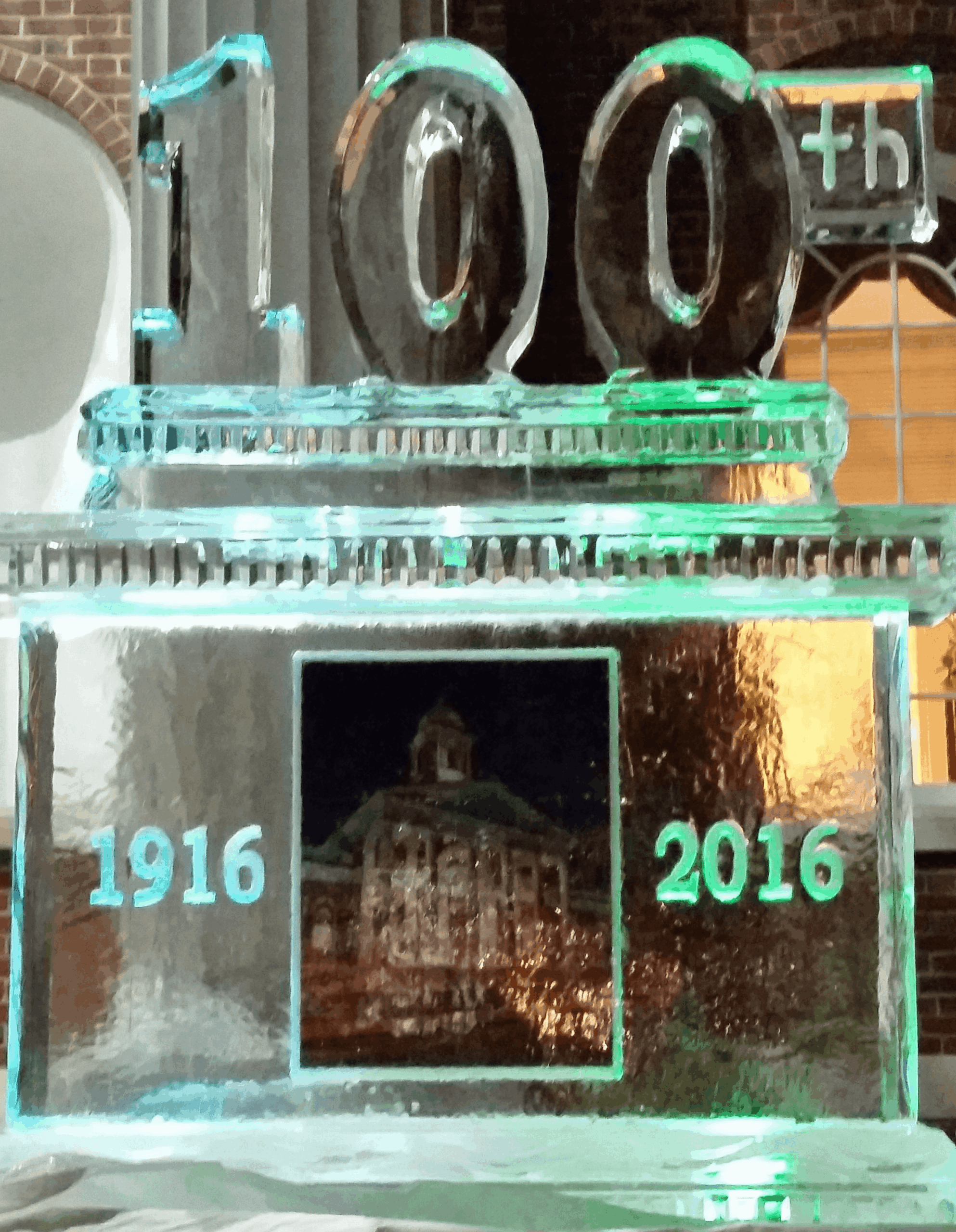 Centennial celebration ice sculpture with ship wheel design