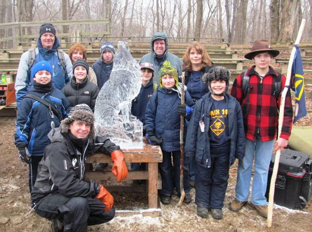 Large crowd of community members gathering outdoors at a winter ice festival