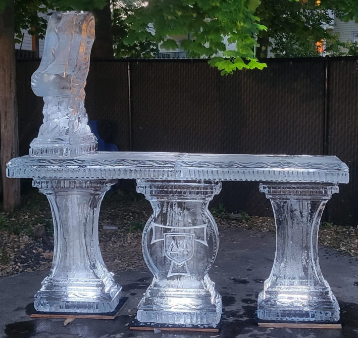 Outdoor ice bar with carved pedestal base