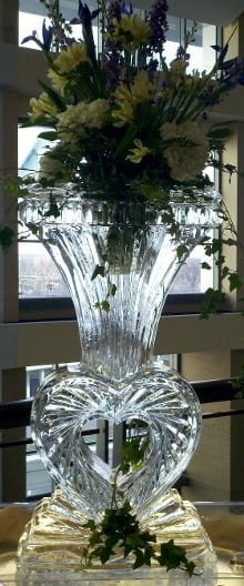 Ice vase centerpiece with fresh greenery and floral display