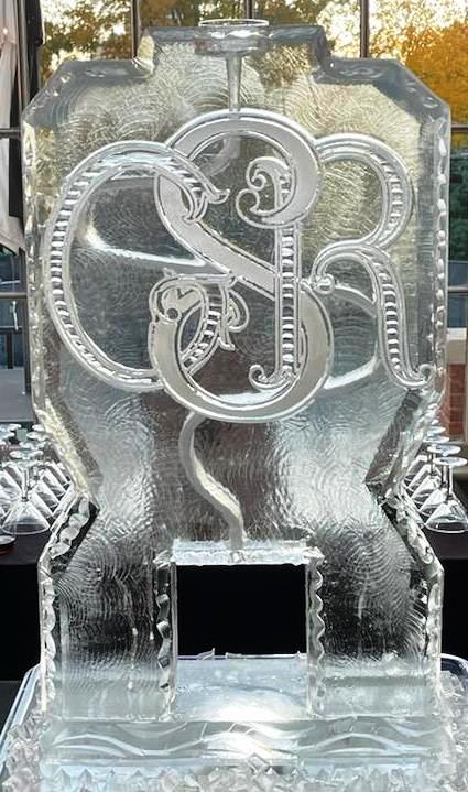Decorative monogram ice sculpture with ornate intertwined initials
