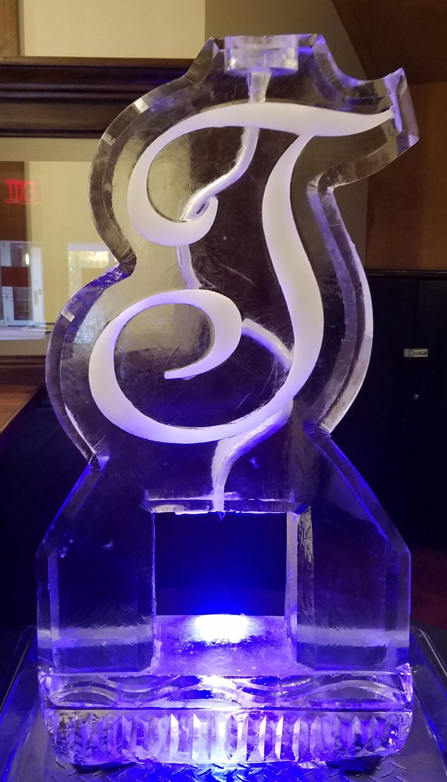 Purple illuminated swirl ice sculpture for event décor