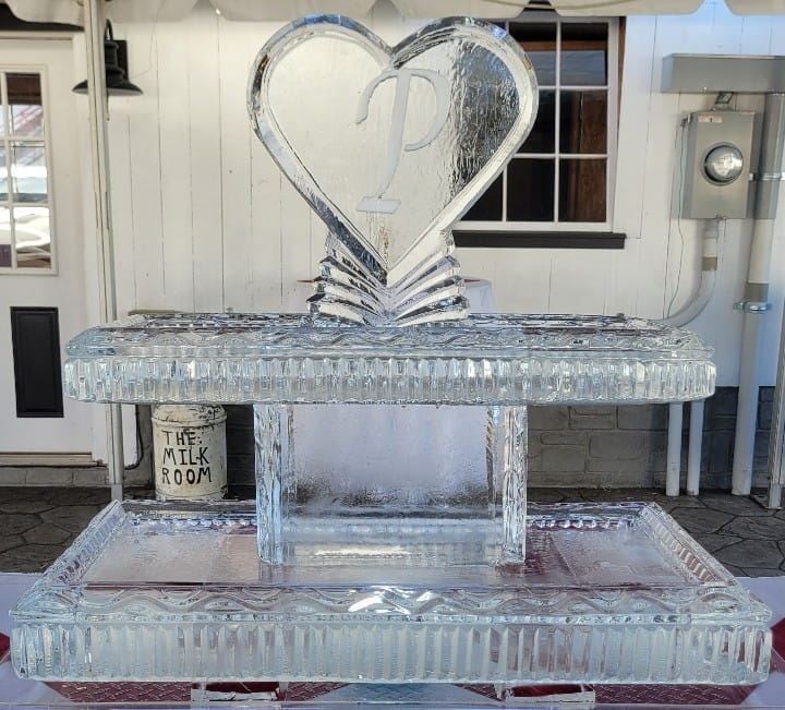 Heart-shaped wedding ice sculpture featuring engraved S & D initials