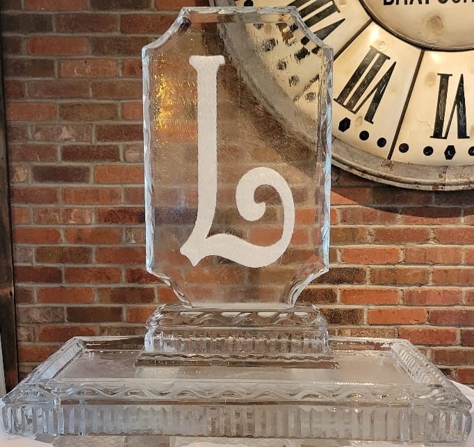 Letter L monogram ice sculpture with clock design