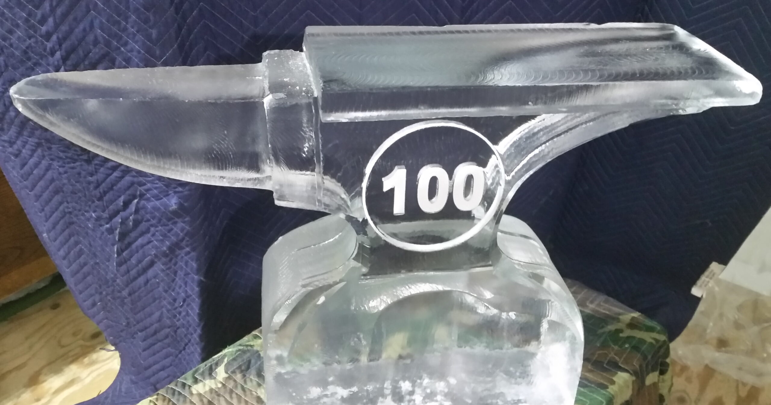 Bottle-shaped 100 celebration ice sculpture
