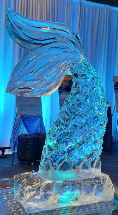 Blue illuminated peacock ice sculpture