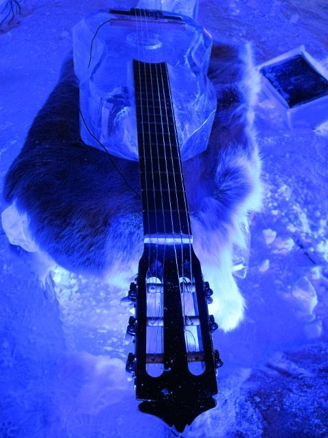 Close up detail of musical instruments setup inside an artistic blue lit ice chamber