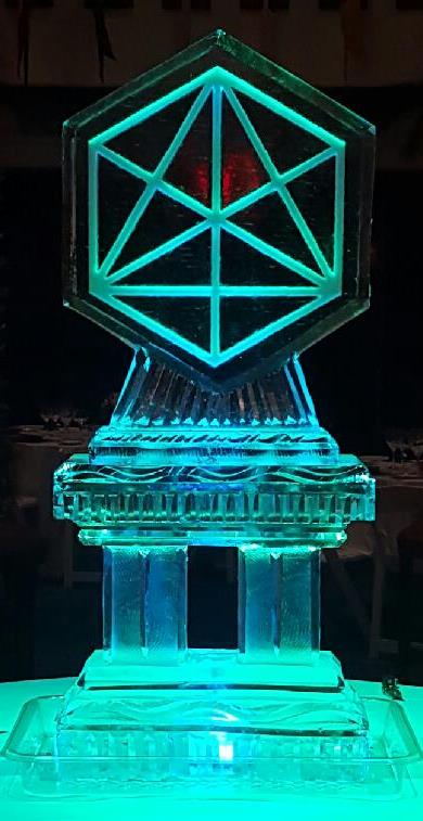 Geometric crystal shape ice sculpture glowing with green and blue LED light
