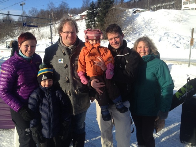 Group photo of a large team posing together outside at an ice sculpture festival