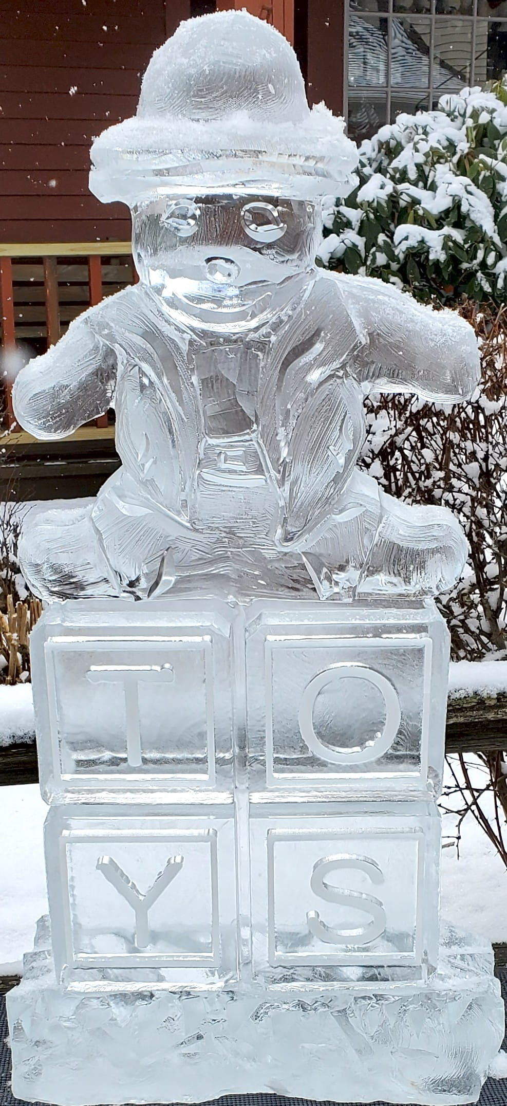 Teddy bear ice sculpture on engraved base