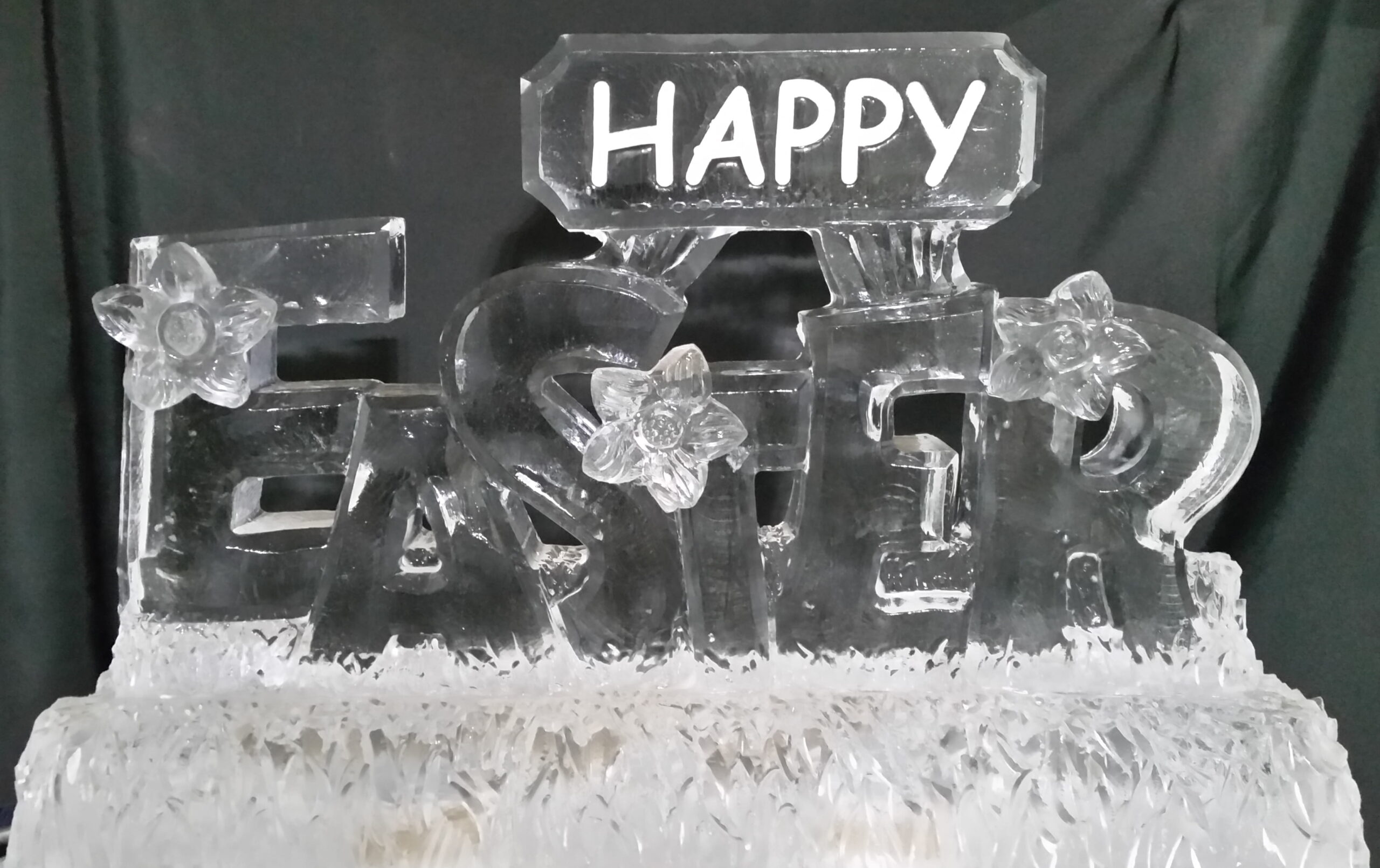 Happy engraved ice sculpture with decorative accents