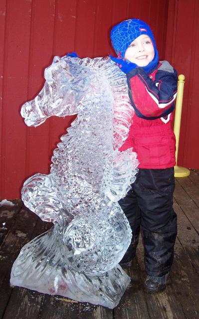 Detailed clear ice carving of a horse or pony figure standing outdoors