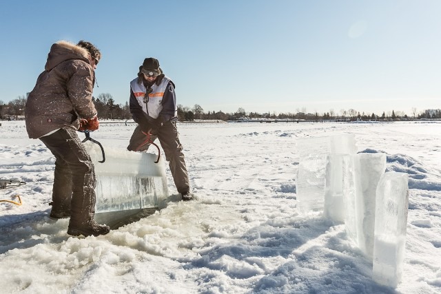 Event production crew members standing in a bright sunny snow field location