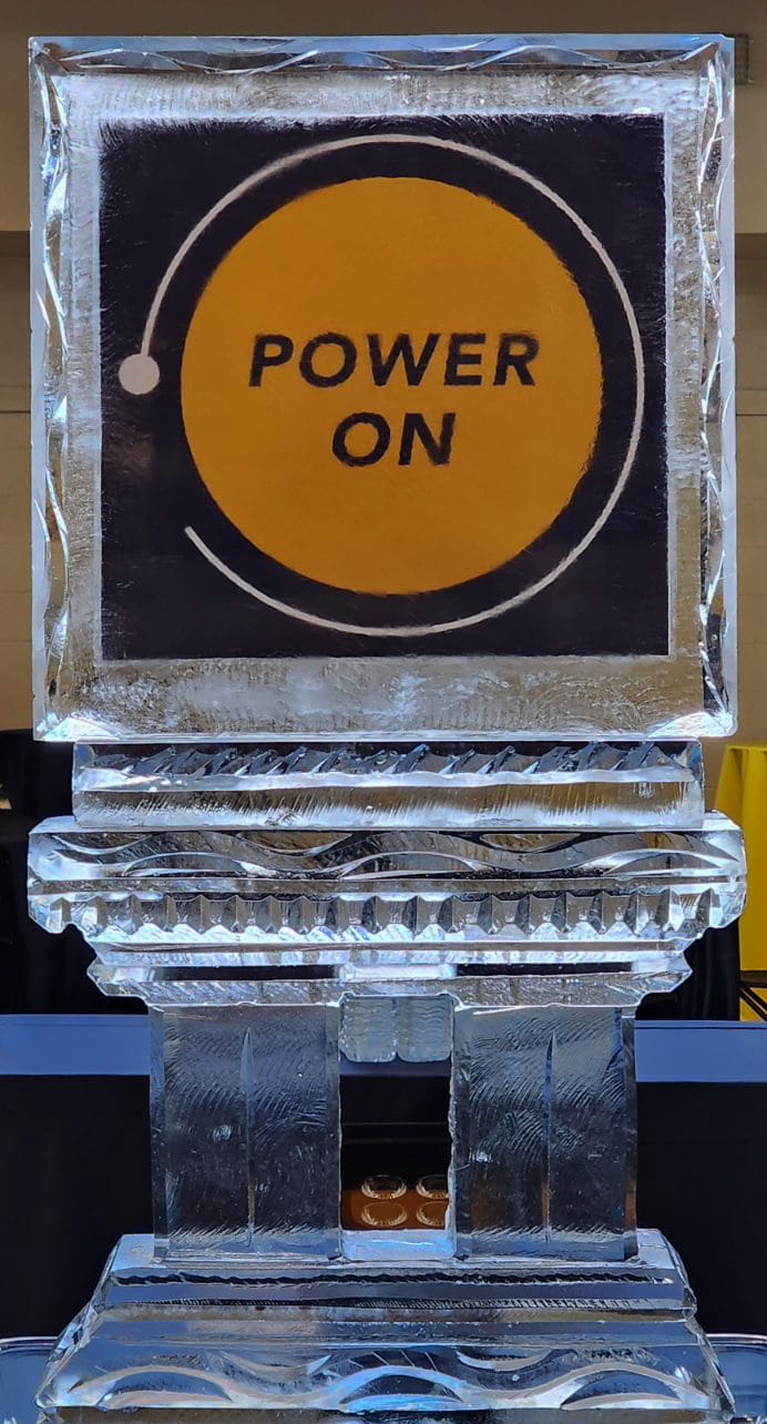 Power On corporate branded yellow circle logo ice block carving