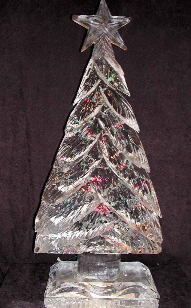 Tall ice sculpture carved to resemble a textured evergreen christmas tree