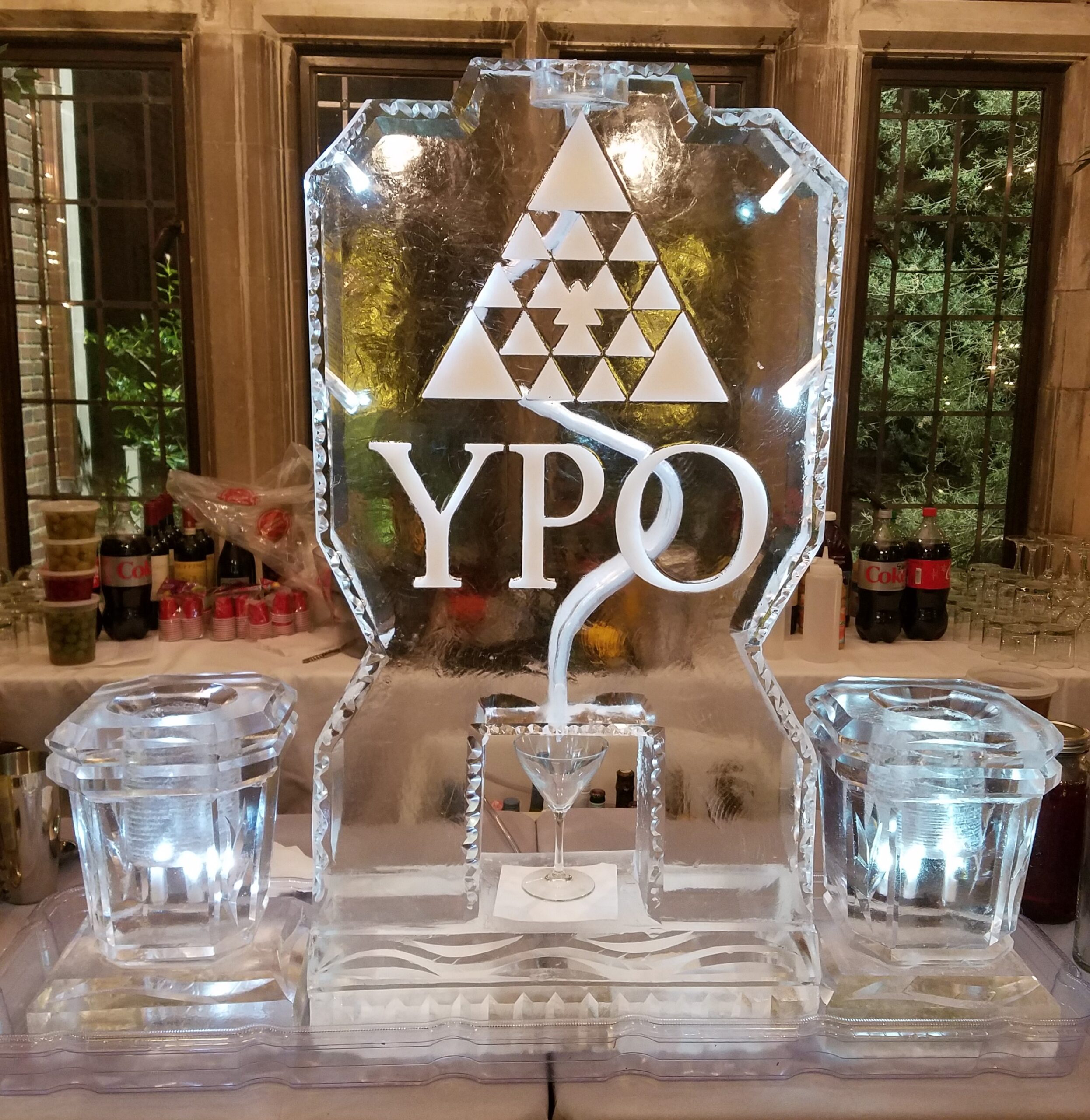 YPO corporate custom logo block ice sculpture on a lighted display stand