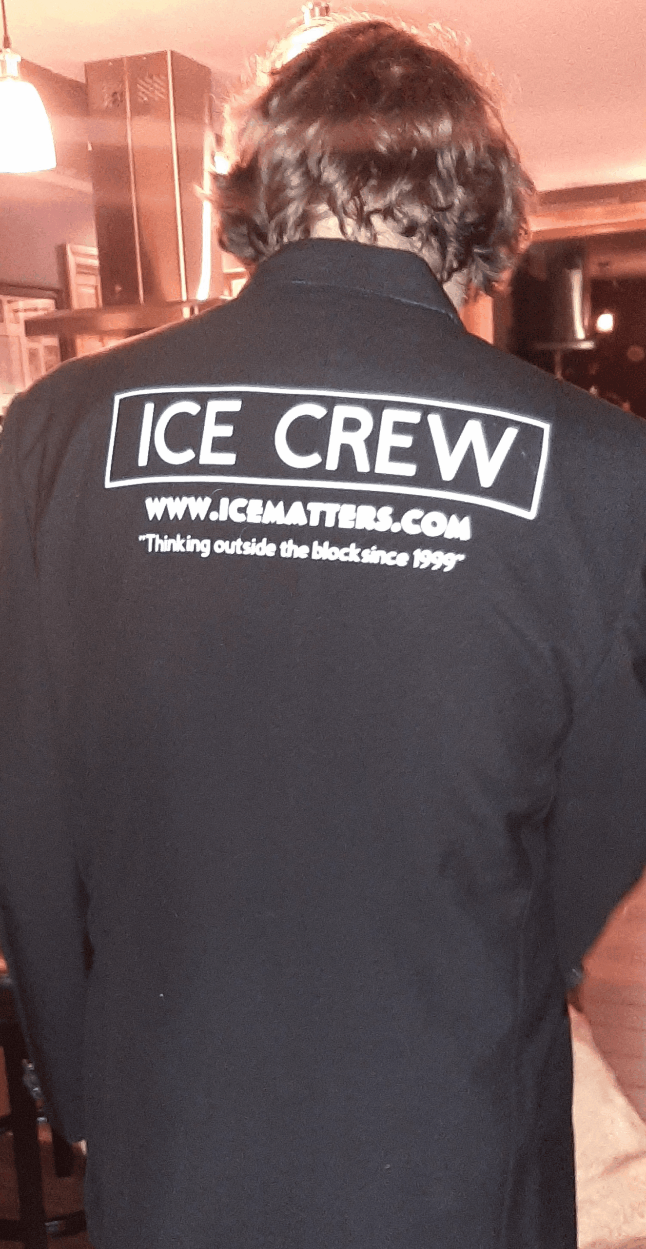 Close up of an event crew member wearing a black Ice Crew t-shirt