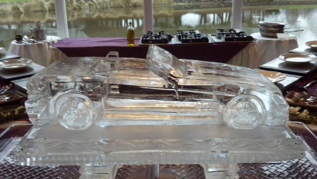 Elegant script letter D ice sculpture on a display stand