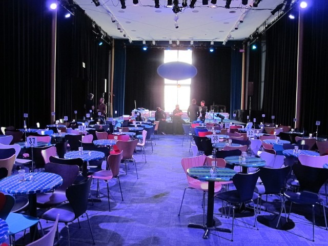 Indoor event banquet hall reception setup with vibrant purple ambient lighting