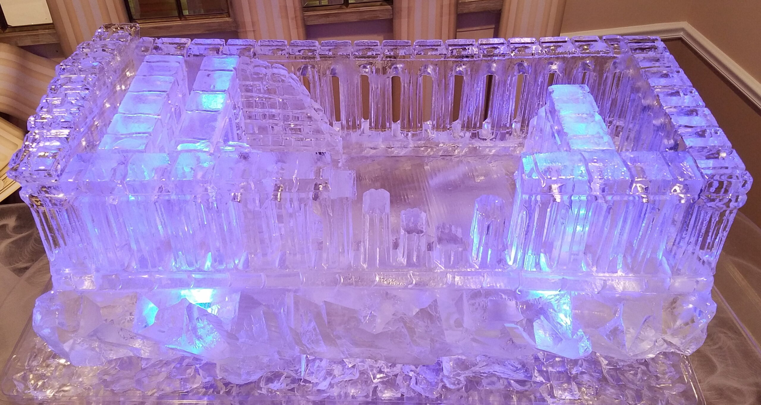 Illuminated ice bar with decorative carving
