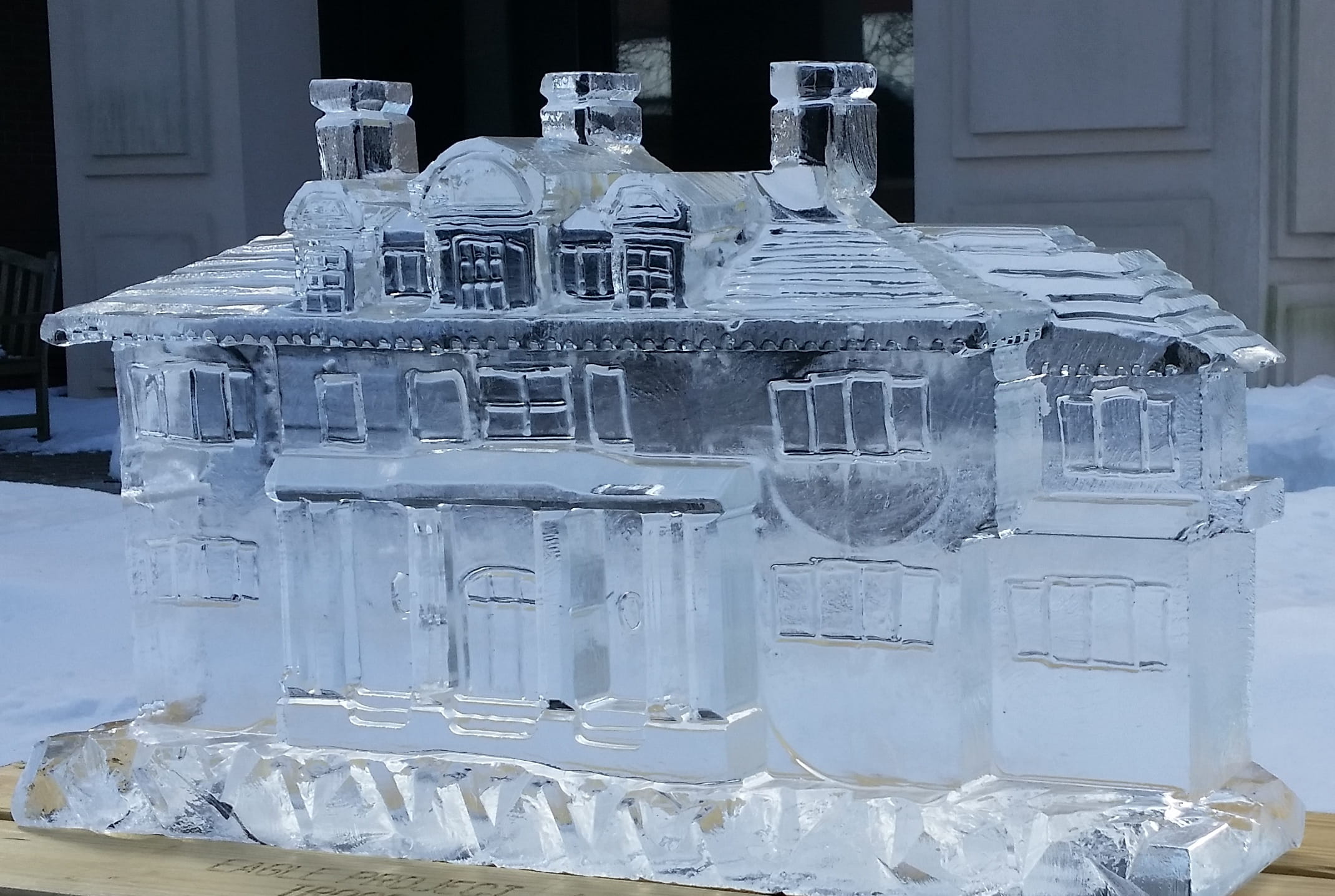 Intricate custom ice carving of a vase or urn display