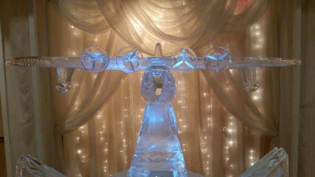 Angel ice sculpture with illuminated backdrop