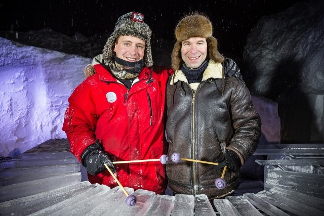 Two smiling ice event coordinators posing together in heavy winter coats