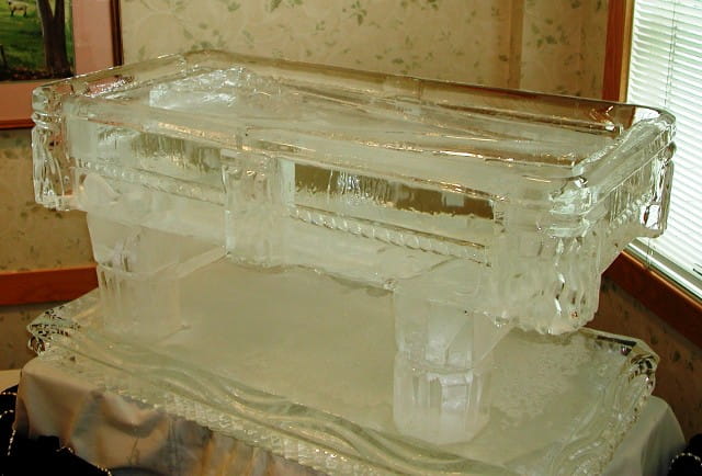 Ice bar with built-in drink luge