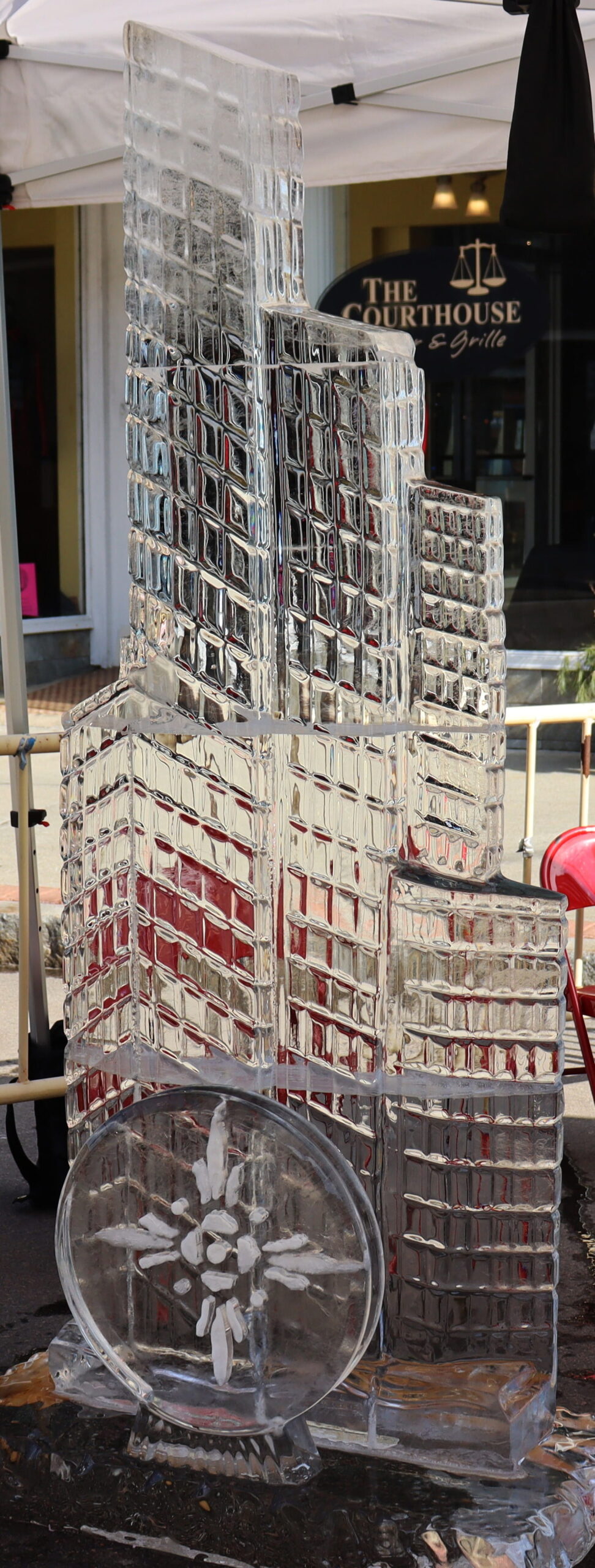 Tall multi-layered geometric block ice carving for an exhibition