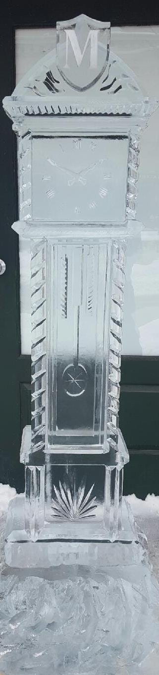 Tall clear ice pillar carving with intricate internal detailing