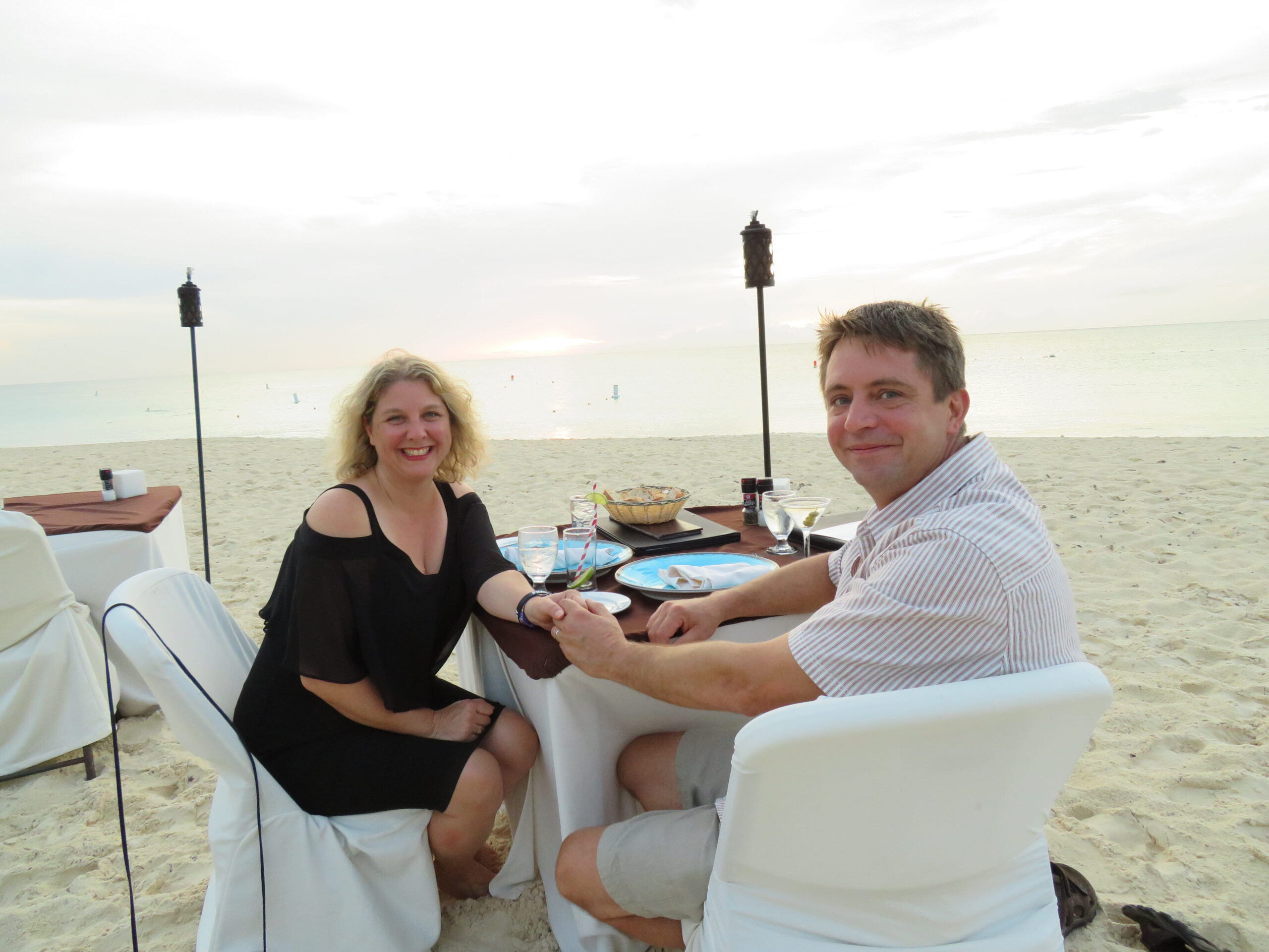 Couple enjoying drinks together at an outdoor resort patio table
