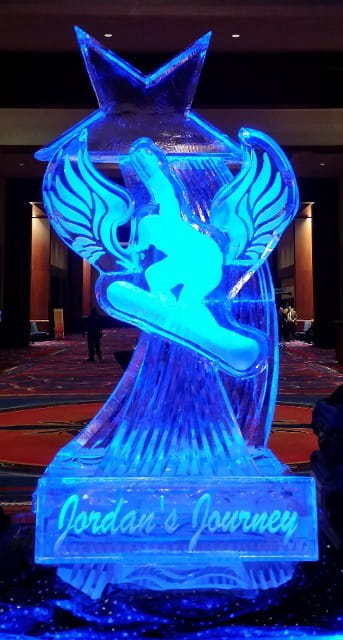 Vibrant blue lit snowboarder or surfer action figure custom ice sculpture