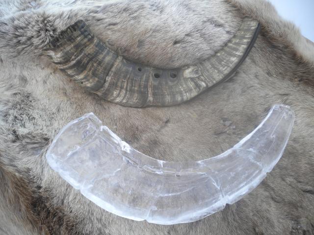Curved architectural clear ice block structure assembled on the snow